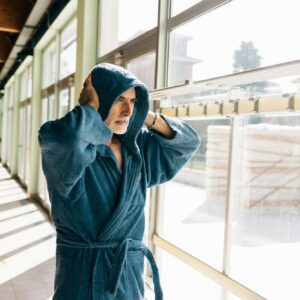 Senior man in hooded bath robe