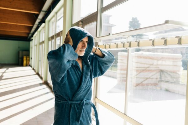 Senior man in hooded bath robe